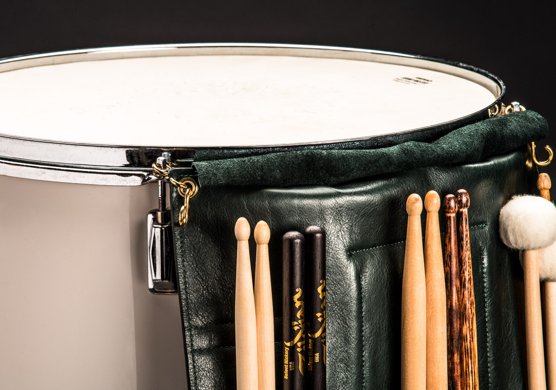 The Great Leather Drumstick Bag in forest green hangs on a floor tom by way of two sturdy S-Hooks. A superior application than leather ties that tie the stickbag to your floor tom. The S-hooks are an innovative and much better idea for quick and easy change outs on any stage or in any recording studio. There is an extra set of S-hooks for hanging drum wire brushes and retractable drum stick brushes open and ready for use.